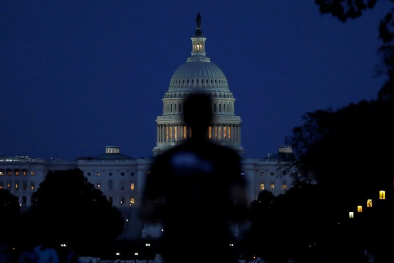 People walk past the U.S. Capitol Building in Washington