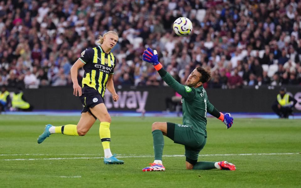 Erling Haaland lifts the ball over Lukasz Fabianski