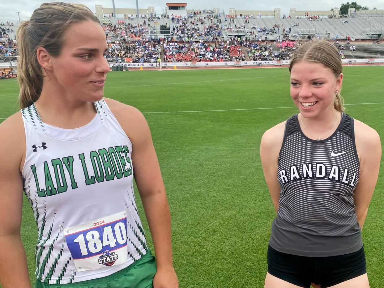 Valerie Hunt, left, and Sophia Bush chat after competing in the 4A pole vault Thursday. Even though they compete for different schools, they don't consider themselves rivals, Hunt said.