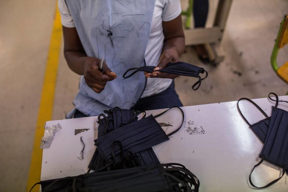 A worker makes masks at the MBI factory at the industrial park Sonapi in Port-au-Prince on April 21, 2020.