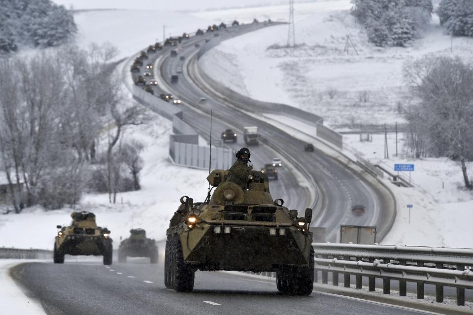 FILE - A convoy of Russian armored vehicles moves along a highway in Crimea, Tuesday, Jan. 18, 2022. The Crimean Peninsula's balmy beaches have been vacation spots for Russian czars and has hosted history-shaking meetings of world leaders. And it has been the site of ethnic persecutions, forced deportations and political repression. Now, as Russia’s war in Ukraine enters its 18th month, the Black Sea peninsula is again both a playground and a battleground. (AP Photo, File)