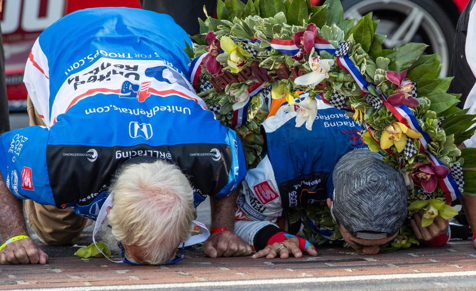 Rahal Letterman Lanigan Racing driver Takuma Sato (30) and team co-owner David Letterman kiss the bricks after winning the 104th Indianapolis 500 at Indianapolis Motor Speedway on Sunday, Aug. 23, 2020. 