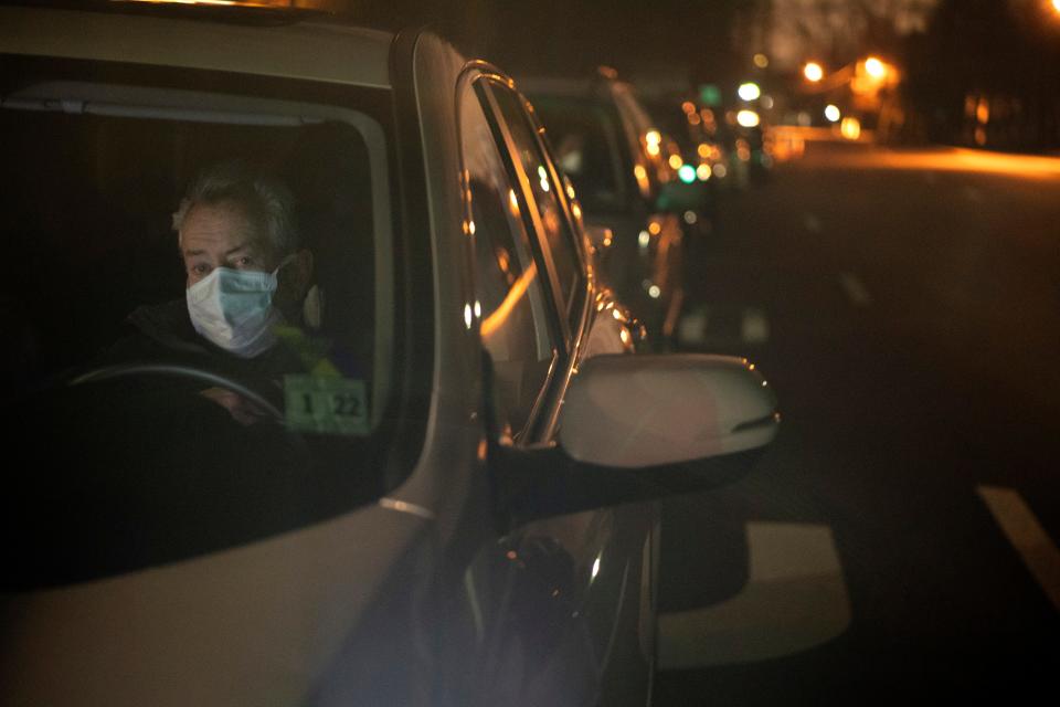 John Dougherty, of Bloomfield, waits outside of the entrance to Bergen Community College at 3:12 a.m. where a drive-thru coronavirus testing center will open at 8 a.m. on Tuesday, March 24, 2020.