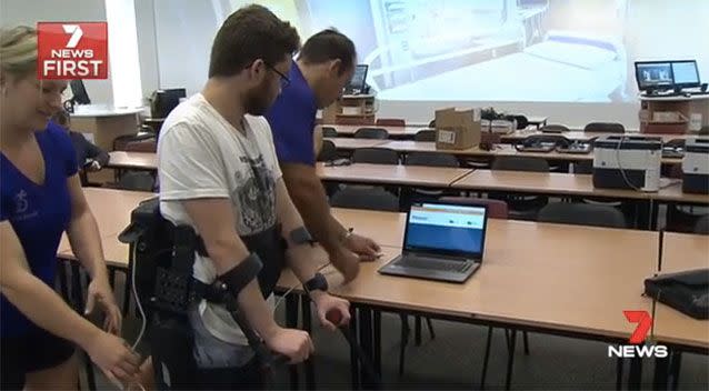 Researchers working with the robotic suit technology. Source: 7News