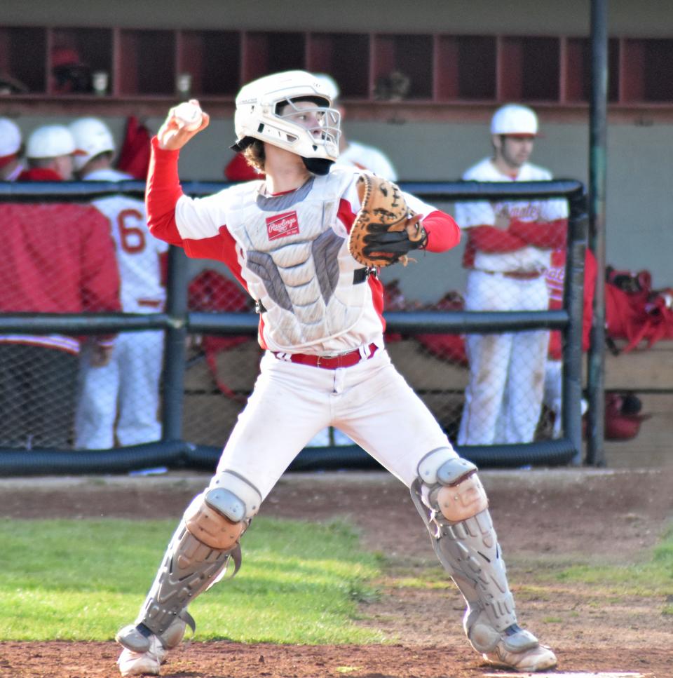 Coldwater catcher Lucas Wischmeyer looks to throw out a runner at second versus Marshall on Tuesday