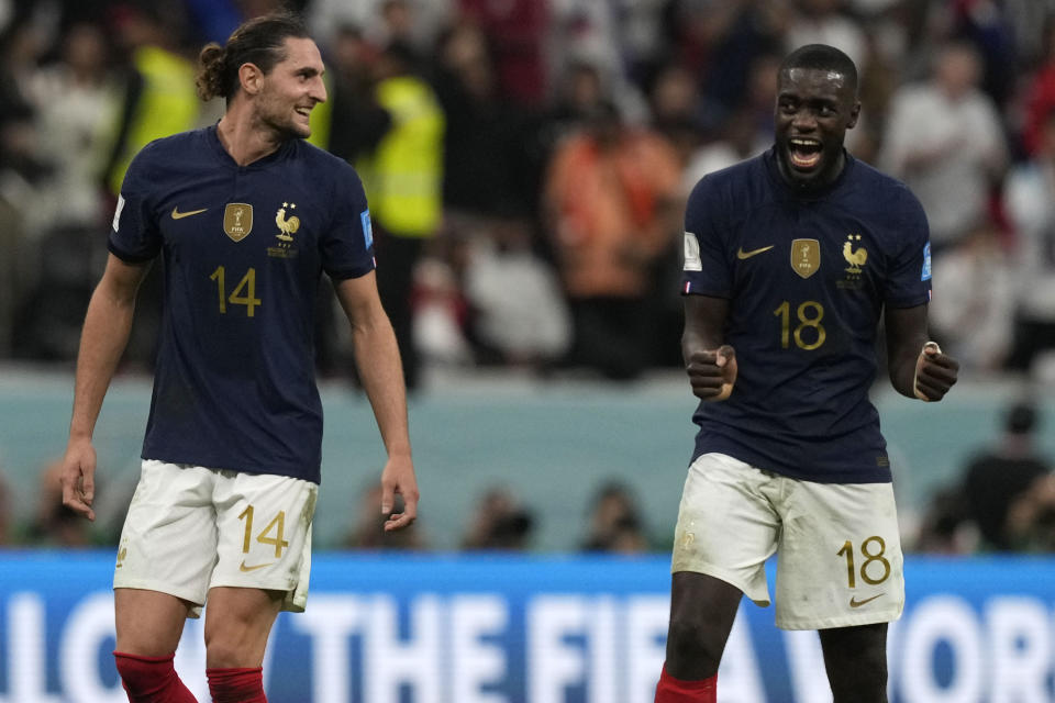 France's Adrien Rabiot, left, and France's Dayot Upamecano celebrate after the World Cup quarterfinal soccer match between England and France, at the Al Bayt Stadium in Al Khor, Qatar, Sunday, Dec. 11, 2022. (AP Photo/Frank Augstein)