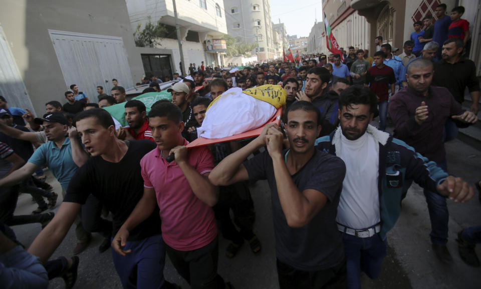 Mourners carry the bodies of Rafat Ayyad and his children, Islam and Amie, who were killed in an Israeli airstrike, during their funeral in Gaza City, Wednesday, Nov. 13, 2019. Israeli airstrikes pounded Islamic Jihad targets in Gaza on Wednesday as militants resumed rocket fire toward Israel after a brief overnight lull, raising the death toll to tens of Palestinians, including a 7-year-old boy and two other minors, in the heaviest round of fighting in months. (AP Photo/Adel Hana)