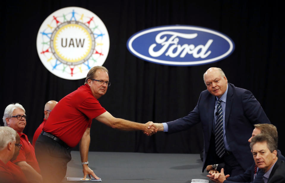 United Auto Workers President Gary Jones, left, and Ford Motor Co., Chief Executive Officer Jim Hackett shake hands to open their contract talks Monday, July 15, 2019, in Dearborn, Mich. (AP Photo/Carlos Osorio)