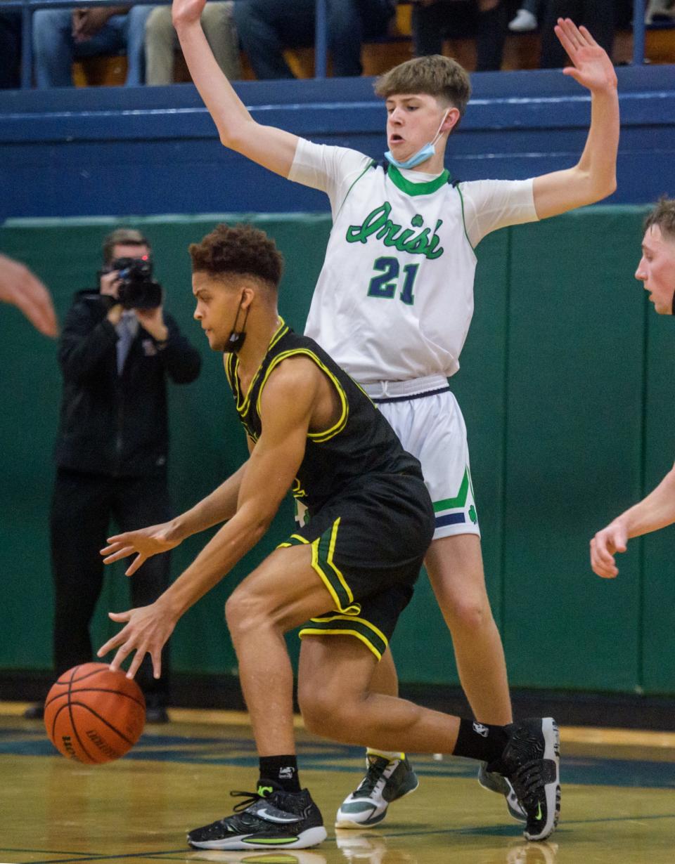 Richwoods' Jamauri Winfrey moves the ball around Peoria Notre Dame's Eoin Dillon in the second half Friday, Dec. 3, 2021 at PND High School. The Knights defeated the Irish 52-45.