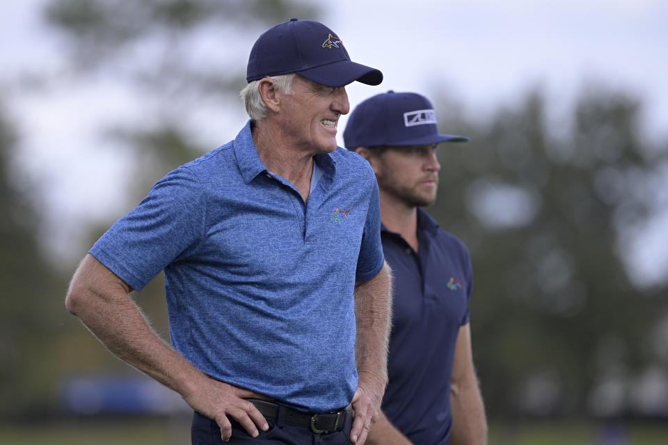 Greg Norman, left, of Australia, walks with his son Greg Norman Jr. on the 18th fairway after hitting their tee shots during the first round of the PNC Championship golf tournament, Saturday, Dec. 19, 2020, in Orlando, Fla. (AP Photo/Phelan M. Ebenhack)