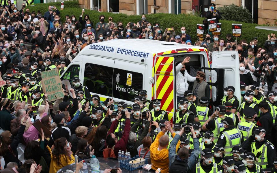 One of two men are released from the back of an Immigration Enforcement van  - Andrew Milligan/PA