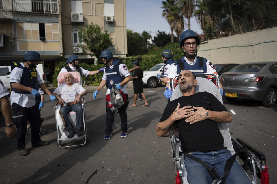 Paramedics evacuate wounded Israelis from a building struck by a rocket fired from Gaza, in Tel Aviv, Israel, Friday, Oct. 27, 2023. (AP Photo/Oded Balilty)