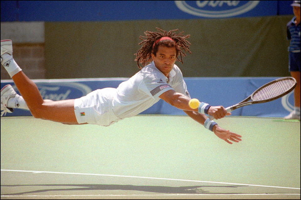 Yannick Noah dives for a return during his Australian Open match against Gilad Bloom of Israel on Jan. 19, 1990. (Photo: PATRICK RIVIERE/AFP via Getty Images)