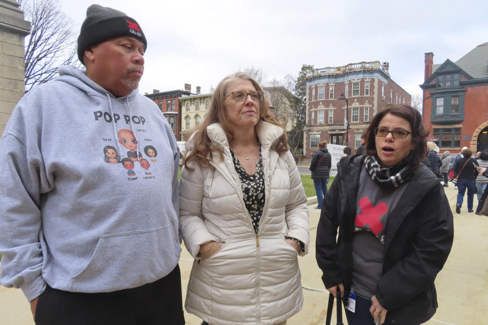 Lamont White, left, Cyhthia Hallett, center, and Nicola Vitola, right, speak to reporters after a New Jersey Senate committee advanced a bill that would ban smoking in Atlantic City's nine casinos, Monday, Jan. 29, 2024, in Trenton, N.J. They are among the leaders of a push to ban smoking in the casinos. (AP Photo/Wayne Parry)