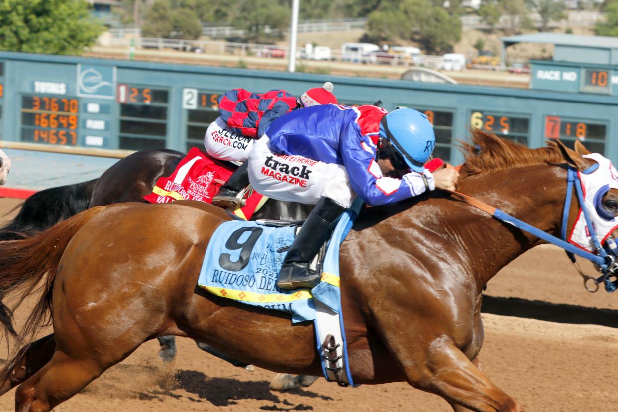 Empressum (9) crosses the finish line just ahead of Valiant Stars (1) to claim the Ruidoso Quarter Horse Derby at the Ruidoso Downs on June 12, 2021.