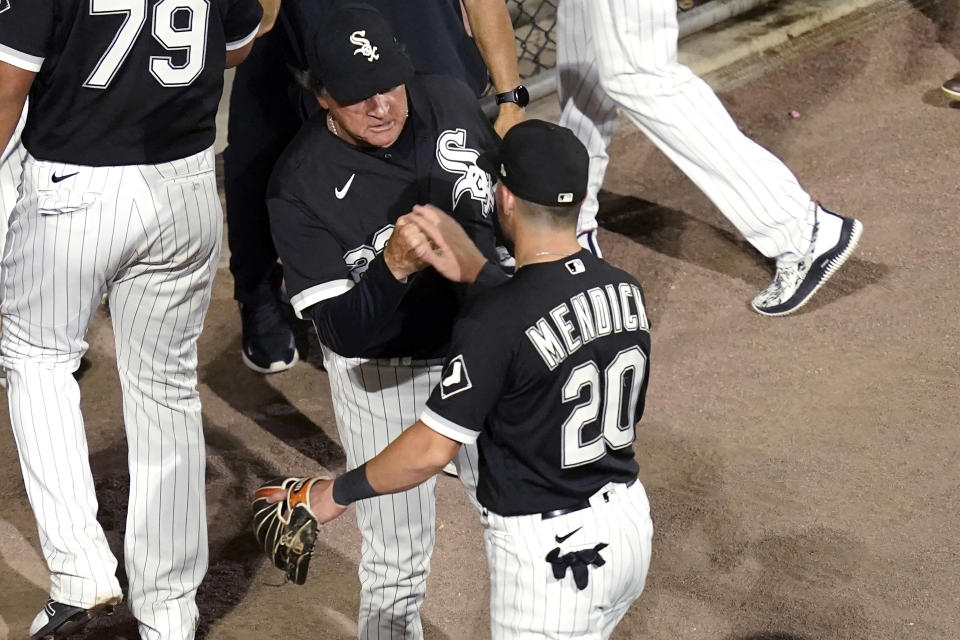 Chicago White Sox manager Tony La Russa, left, greets Danny Mendick after the team's 3-0 win over the Tampa Bay Rays in a baseball game Tuesday, June 15, 2021, in Chicago. (AP Photo/Charles Rex Arbogast)