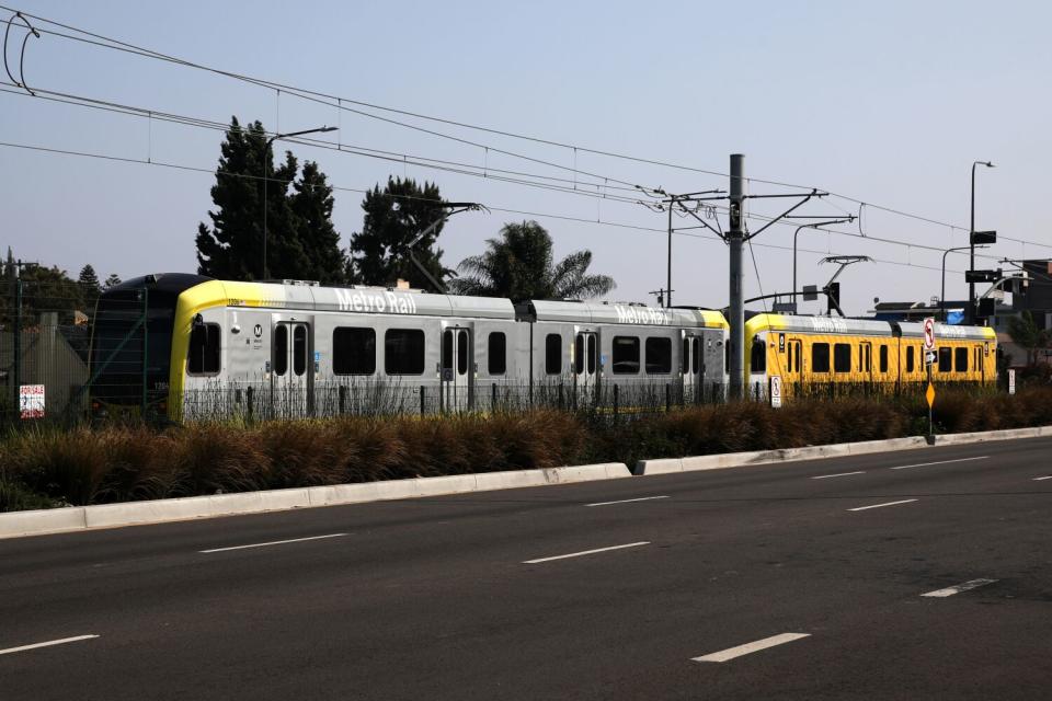 A train runs next to a street