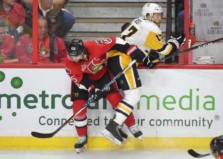 May 23, 2017; Ottawa, Ontario, CAN; Ottawa Senators defenceman Erik Karlsson (65) body checks Pittsburgh Penguins forward Bryan Rust (17) in game six of the Eastern Conference Final of the 2017 Stanley Cup Playoffs at Canadian Tire Centre. Mandatory Credit: Dan Hamilton-USA TODAY Sports