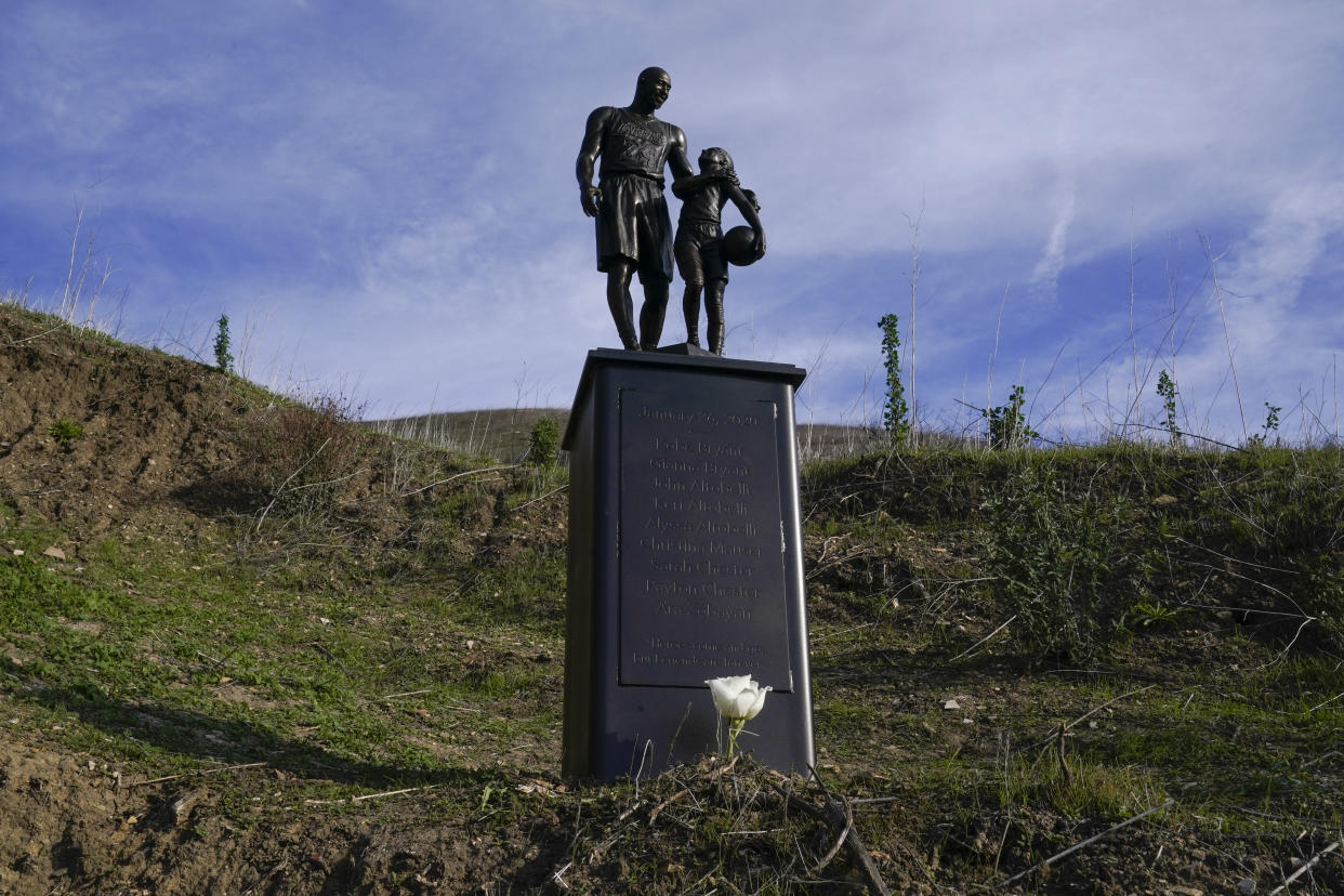 A statue to honor former Los Angeles Lakers player Kobe Bryant and his daughter, Gianna, on Wednesday, Jan. 26, 2022, in Calabasas, Calif. The statue was carried by the artist, Dan Medina, on a trail near where Bryant, his daughter, and seven other people died in a helicopter crash two years ago Wednesday. (AP Photo/Ashley Landis)