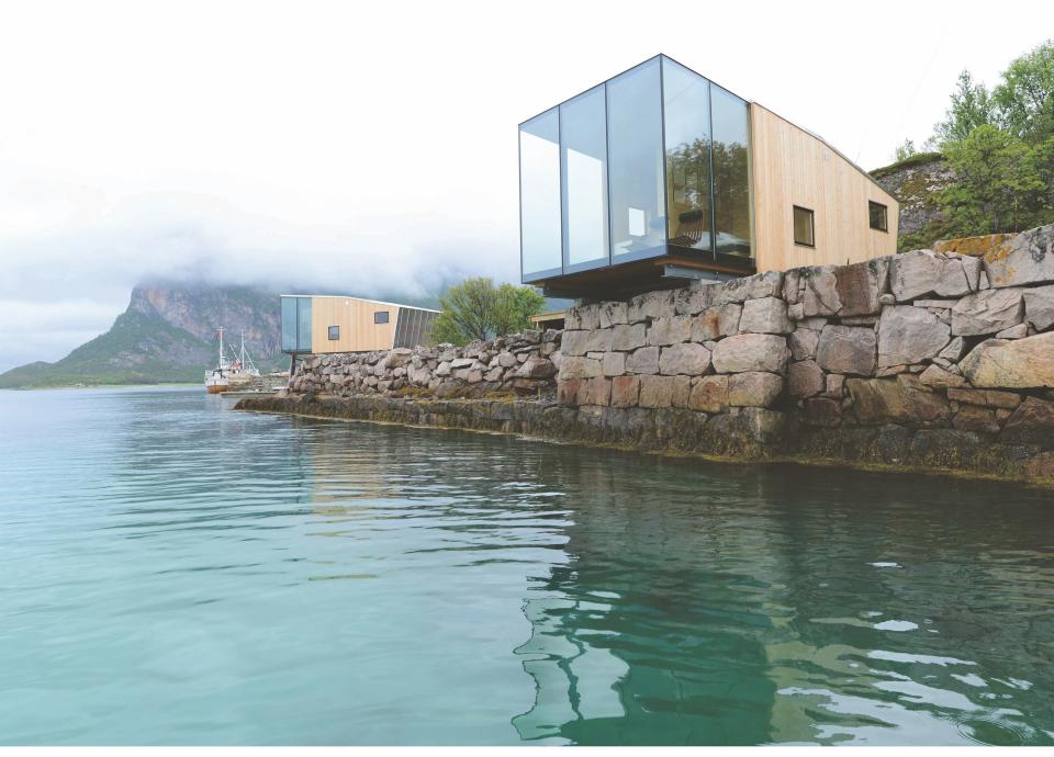 Perched on the edge of Manshausen Island in Norway are four cabins designed by architect Snorre Stinessen for Norwegian polar explorer Børge Ousland, the owner of the island. The master bedrooms boast floor-to-ceiling windows with views of the water and rocky coastline.