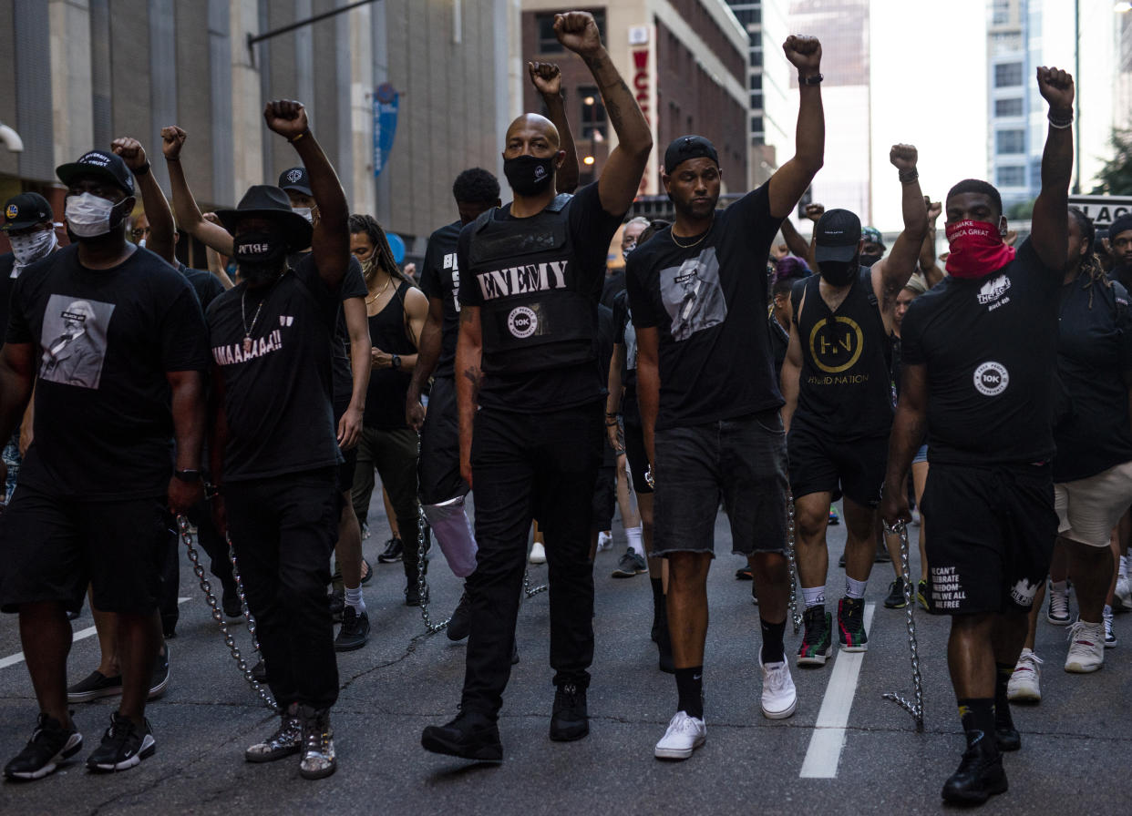Royce White (C) and other demonstrators drag chains behind them during the Black 4th protest in downtown on July 4, 2020 in Minneapolis, Minnesota. A number of protest demonstrations occurred around the Twin Cities on Independence Day which were critical of the annual American celebration. (Photo by Stephen Maturen/Getty Images)