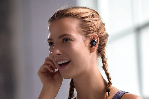 Girl wearing black earbuds.