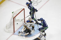 Vancouver Canucks' Antoine Roussel (26) and Adam Gaudette (88), celebrate a goal against St. Louis Blues goalie Jordan Binnington (50) during second-period NHL Western Conference Stanley Cup playoff hockey game action in Edmonton, Alberta, Friday, Aug. 21, 2020. (Jason Franson/The Canadian Press via AP)