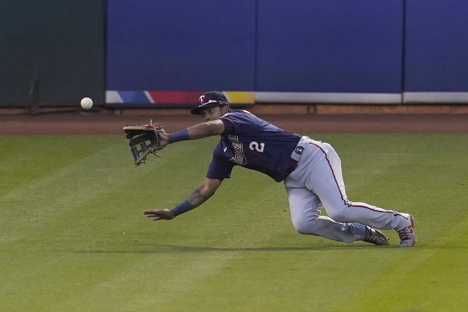 Minnesota Twins left fielder Luis Arraez catches a line out hit by Oakland Athletics' Elvis Andrus before doubling up Mitch Moreland at second base during the fourth inning of the second baseball game of a doubleheader in Oakland, Calif., Tuesday, April 20, 2021. (AP Photo/Jeff Chiu)