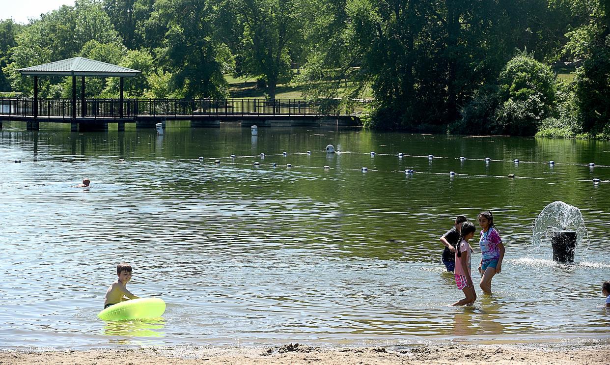 Children and adults cool off in Stephens Lake on Tuesday as the temperature rose near 100 degrees. The National Weather Service is forecasting a high temperature of 101 and a heat index as high as 109 on Wednesday.