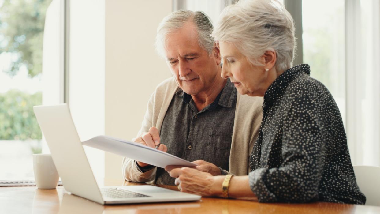  Older couple looking at computer. 