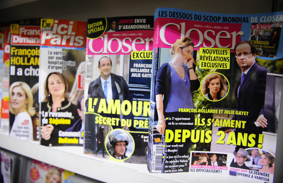 Celebrity news magazines headlining on French President Francois Hollande are on display at a Paris newstand, Friday, Jan. 17, 2014. France's first lady is making progress in a hospital where she is receiving care following a gossip magazine's report that President Francois Hollande was having a secret affair with actress, Julie Gayet, a spokesman said Thursday. Headline at right reads: They are in love for two years. From the left, people on front pages are: Julie Gayet, Segolene Royal, Francois Hollande, Julie Gayet and Hollande. (AP Photo/Zacharie Scheurer)