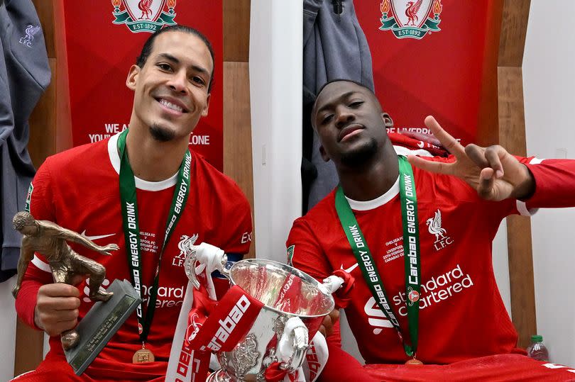 Virgil van Dijk captain of Liverpool and Ibrahima Konate of Liverpool with the Carabao Cup in the dressing room after the Carabao Cup Final between Chelsea and Liverpool at Wembley Stadium on February 25, 2024 in London, England.