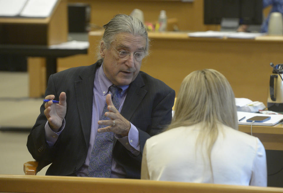 Norman Pattis, attorney for Alex Jones, in discussion with Brittany Paz, a Connecticut lawyer hired by Jones to testify about his companies' operations, during the Alex Jones Sandy Hook defamation damages trial in Superior Court in Waterbury, Conn.,, Friday, Sept. 16, 2022. (H John Voorhees III/Hearst Connecticut Media via AP, Pool)