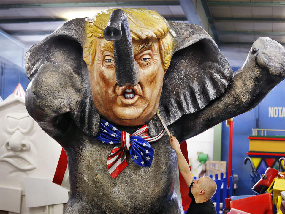 <p>A worker poses with a brush in front of a figure depicting U.S. President Donald Trump as an elephant during a press preview in a hall of the Main carnival club in Mainz, Germany, Feb. 21, 2017. (Photo: Michael Probst/AP) </p>