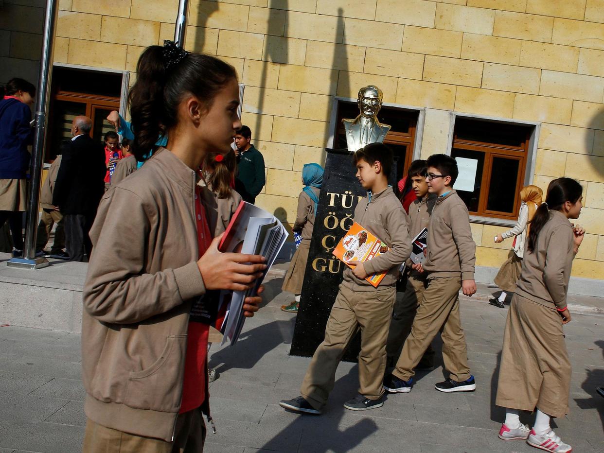 Students at one of Turkey's growing number of 'Imam Hatip' religious schools walk past a statue of Mustafa Kemal Ataturk, founder of secular Turkey, in Ankara (file image): REUTERS/Umit Bektas/File Photo