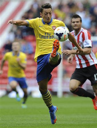 Arsenal's Mesut Ozil controls the ball during their English Premier League soccer match against Sunderland at The Stadium of Light in Sunderland, northern England, September 14, 2013. REUTERS/Nigel Roddis
