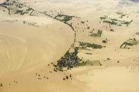 An aerial view shows floodwaters inundating houses and vegetation in Kalay, upper Myanmar's Sagaing region, on August 2, 2015