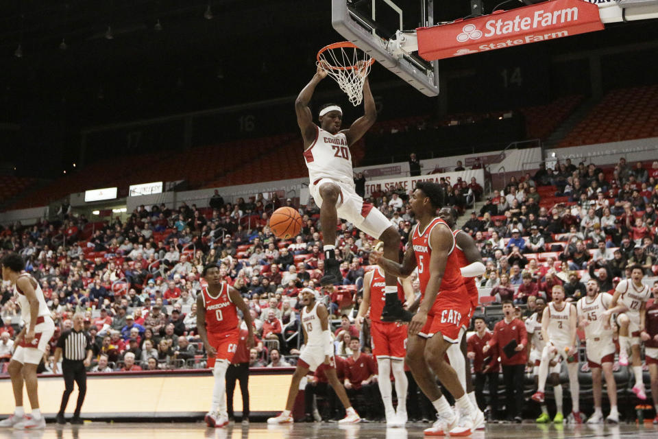 Washington State center Rueben Chinyelu (20) dunks during the second half of an NCAA college basketball game against Arizona, Saturday, Jan. 13, 2024, in Pullman, Wash. (AP Photo/Young Kwak)