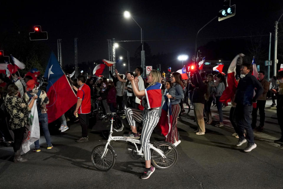 Opponents of the new Constitution cheer in the streets after listening to the results of a plebiscite on whether the new Constitution will replace the current Magna Carta imposed by a military dictatorship 41 years ago, in Santiago, Chile, Sunday, Sept. 4, 2022. (AP Photo/Matias Basualdo)