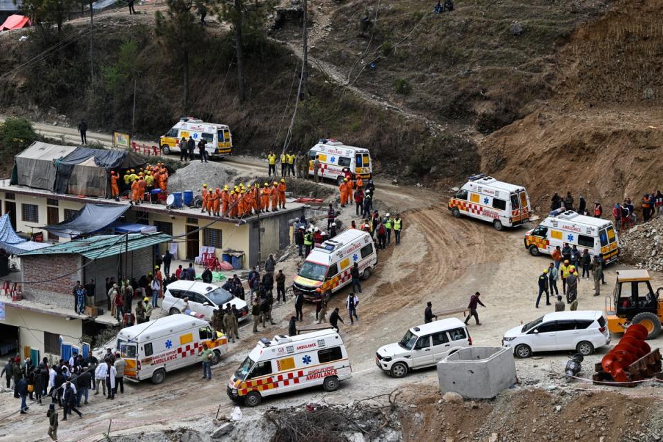 Ambulance and emergency vehicles are on standby near the face of the collapse (AFP via Getty)