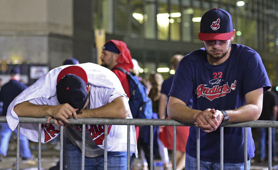 FILE - In this Nov. 3, 2016, file photo, Cleveland Indians fans Levi Jones, left, and Kyle Zabarsky react during a watch party, after Game 7 of the baseball World Series between the Indians and the Chicago Cubs, outside Progressive Field in Cleveland. Months have passed since the Indians’ last home game, an epic, once-in-a-generation Game 7 that will forever be remembered as the night the Chicago Cubs ended a championship drought spanning 108 years. It’s also the night Cleveland finished surrendering a 3-1 lead in the World Series. (AP Photo/David Dermer, File)