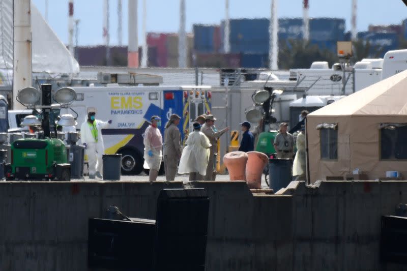 Medical professionals prepare to disembark passengers from the Grand Princess cruise ship, which is carrying passengers who have tested positive for coronavirus docked, at the Port of Oakland in Oakland