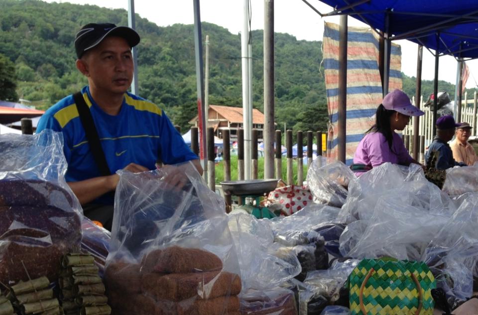 Obot Juakim, a local hawker from Tuaran, is quietly confident but won't keep his hopes up until he feels the changes for himself. — Picture by Julia Chan