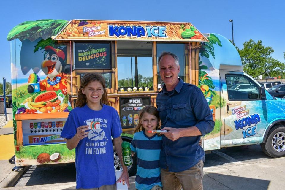 Finnegan, Harbor and Matt Webb, from left, show off the prizes they won by spinning the prize wheel at the Ohio Turnpike’s customer appreciation event.