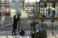 A journalist films United Nations security outside the main entrance to the U.N. headquarters, Monday, Sept. 21, 2020, . 2020 marks the 75th anniversary of the United Nations, the annual high-level meeting of world leaders around the U.N. General Assembly will be very different from years past because of the coronavirus pandemic. Leaders will not be traveling to the United Nations in New York for their addresses, which will be prerecorded. Most events related to the gathering will be held virtually. No access to world leaders on the U.N. grounds will be possible, therefore, and access to most anything will be extremely curtailed. (AP Photo/Mary Altaffer)