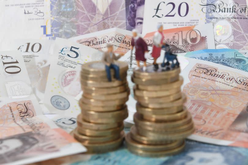 Figurines of pensioners on top of pound coins