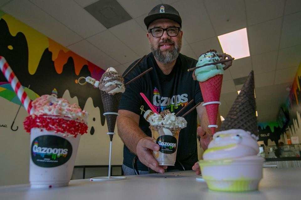 Darren Hussien, co-owner of Gazoops Ice Cream and Waffle Bar in Cape Coral, displays an array of ice cream products available at the northwest Cape Coral store.