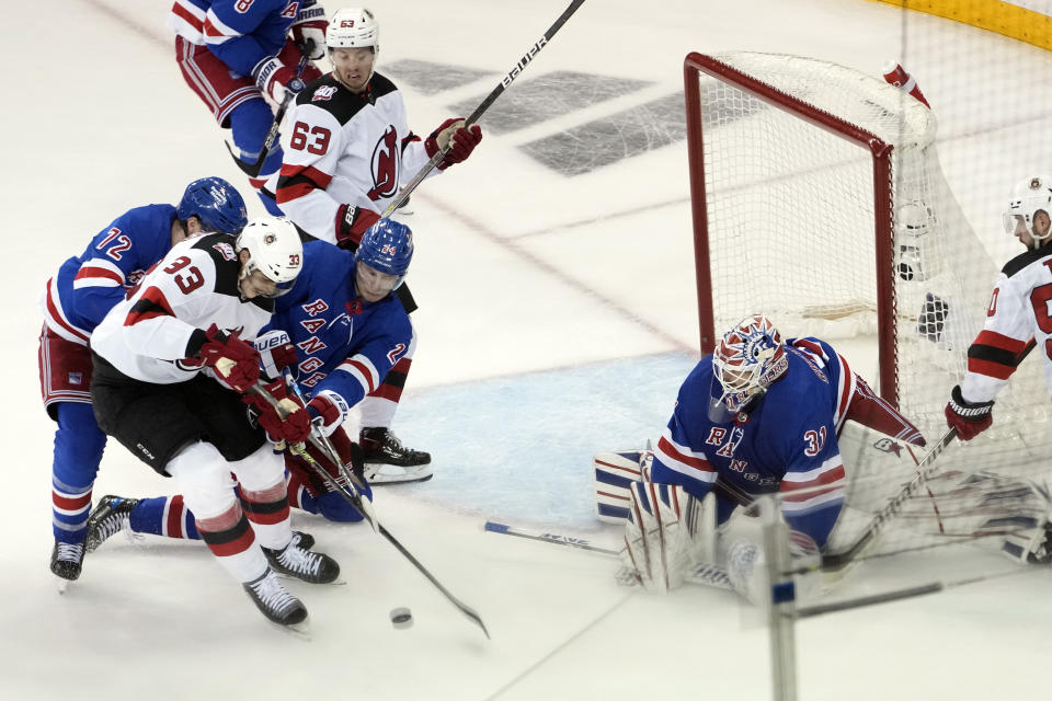 New York Rangers goaltender Igor Shesterkin (31) right wing Kaapo Kakko (24) and center Filip Chytil (72) defend against New Jersey Devils defenseman Ryan Graves (33) during the second period of an NHL hockey game, Saturday, April 29, 2023, at Madison Square Garden in New York. (AP Photo/Mary Altaffer)