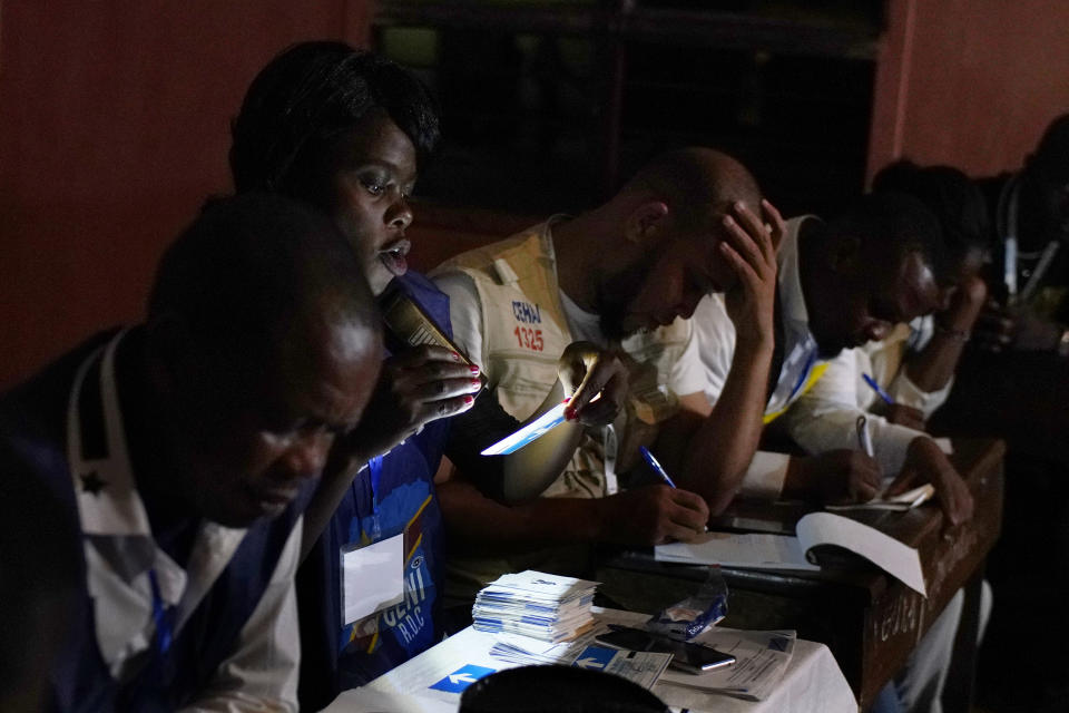 Electoral commission officials tally the presidential ballots in Kinshasa, Sunday Dec. 30, 2018. Forty million voters were registered for a presidential race plagued by years of delay and persistent rumors of lack of preparation. (AP Photo/Jerome Delay)