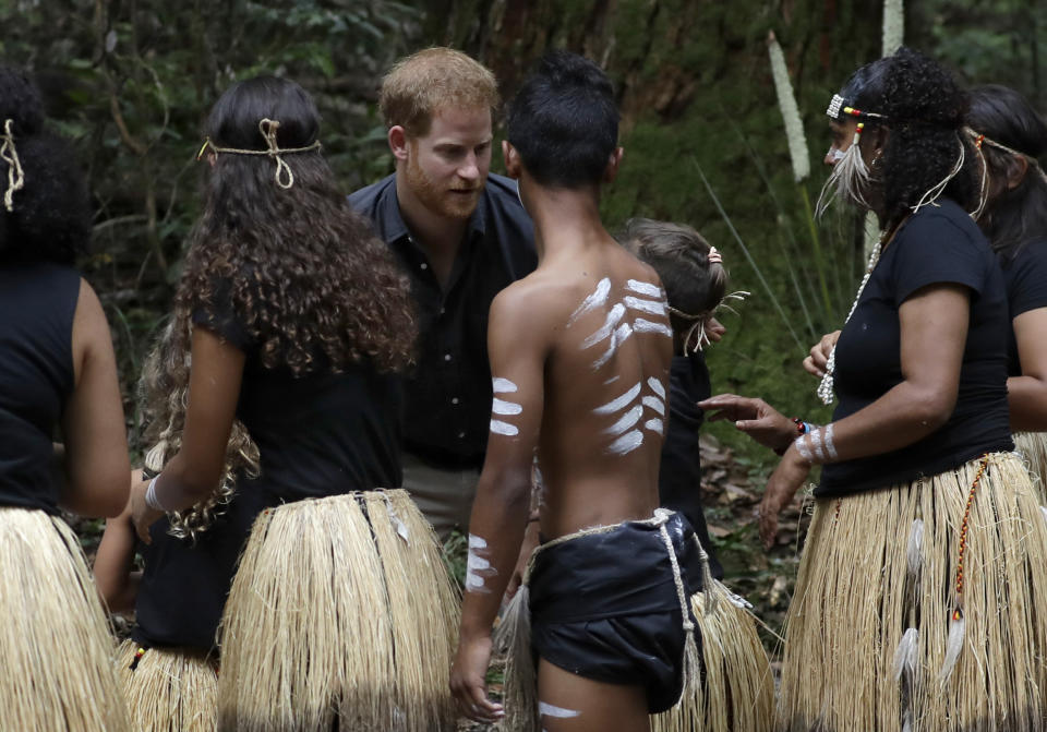 Britain's Prince Harry meets Butchulla people after the unveiling of the Queens Commonwealth Canopy at Pile Valley, K'gari during a visit to Fraser Island, Australia, Monday, Oct. 22, 2018. Prince Harry and his wife Meghan are on day seven of their 16-day tour of Australia and the South Pacific. (AP Photo/Kirsty Wigglesworth)